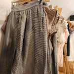 Zero Waste Skirt Gathered Abstract hanging on rack with zero waste tops on wooden coathangers and a wooden rack with a white background. the Australian made skirt has an abstract wave pint and blue and grey coulour palette