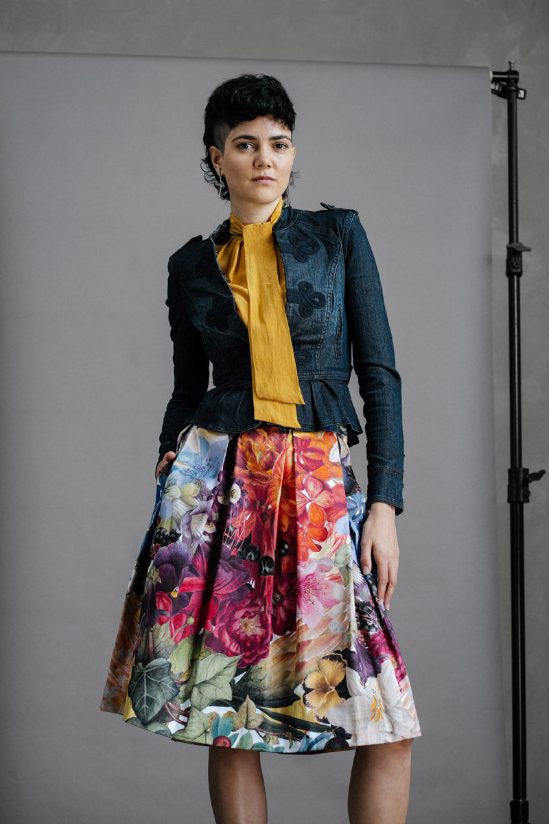 Model wearing Australian made Zero Waste Skirt in Big Blooms styled with other pieces. Beautiful, bold and colourful floral print, just below knee length with Box Pleats