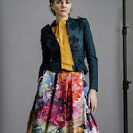 Model wearing Australian made Zero Waste Skirt in Big Blooms styled with other pieces. Beautiful, bold and colourful floral print, just below knee length with Box Pleats