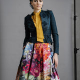 Model wearing Australian made Zero Waste Skirt in Big Blooms styled with other pieces. Beautiful, bold and colourful floral print, just below knee length with Box Pleats