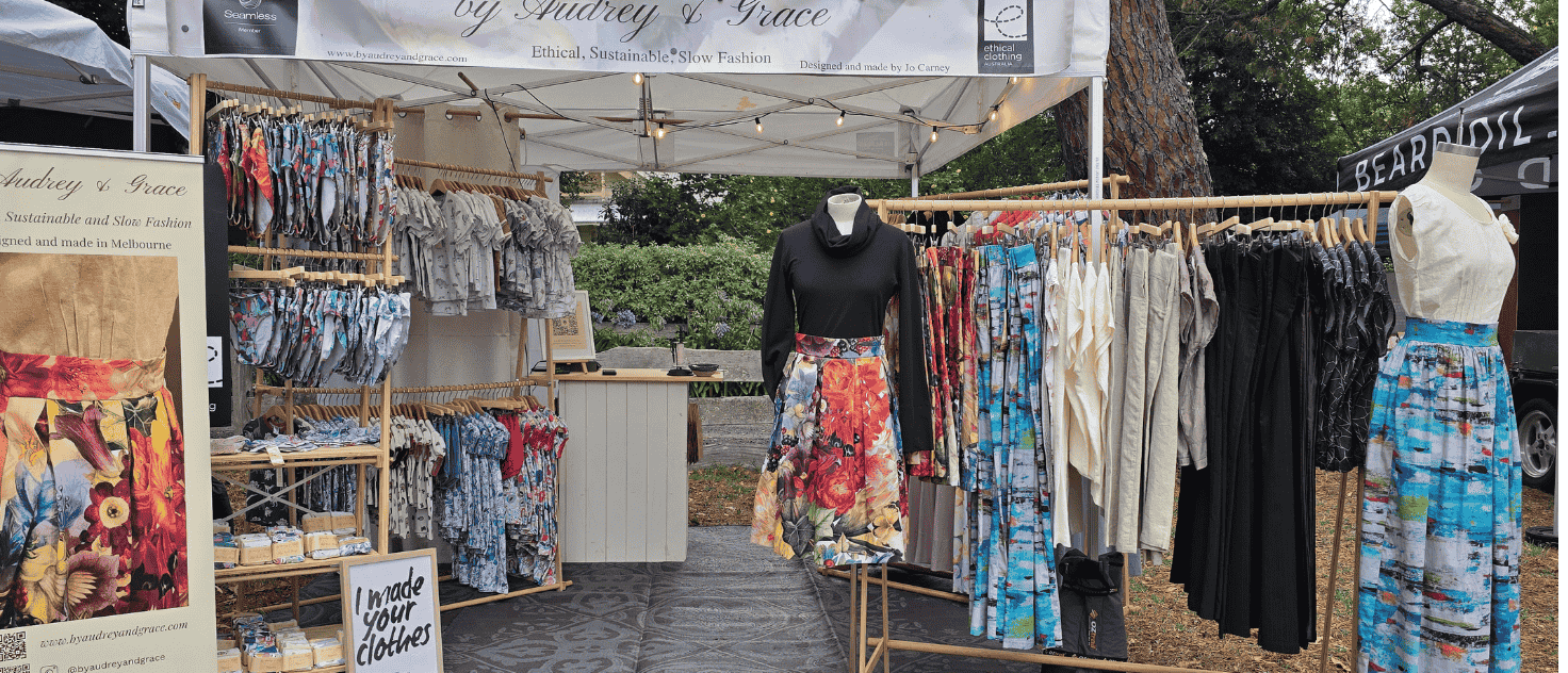 Image of a by Audrey and Grace market set up with mannequins and racks featuring Zero Waste skirts, tops and Ruby Jumpers.