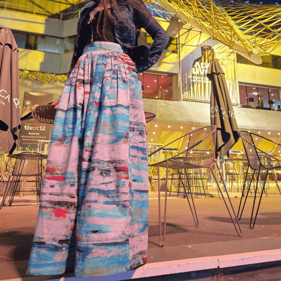 Model wears Australian made full length Zero Waste skirt with abstract Ocean print, from the sustainable clothing collection, in front of Arts Centre Melbourne. Ethical Clothing Australia accredited slow fashion women's clothing featuring timeless design.