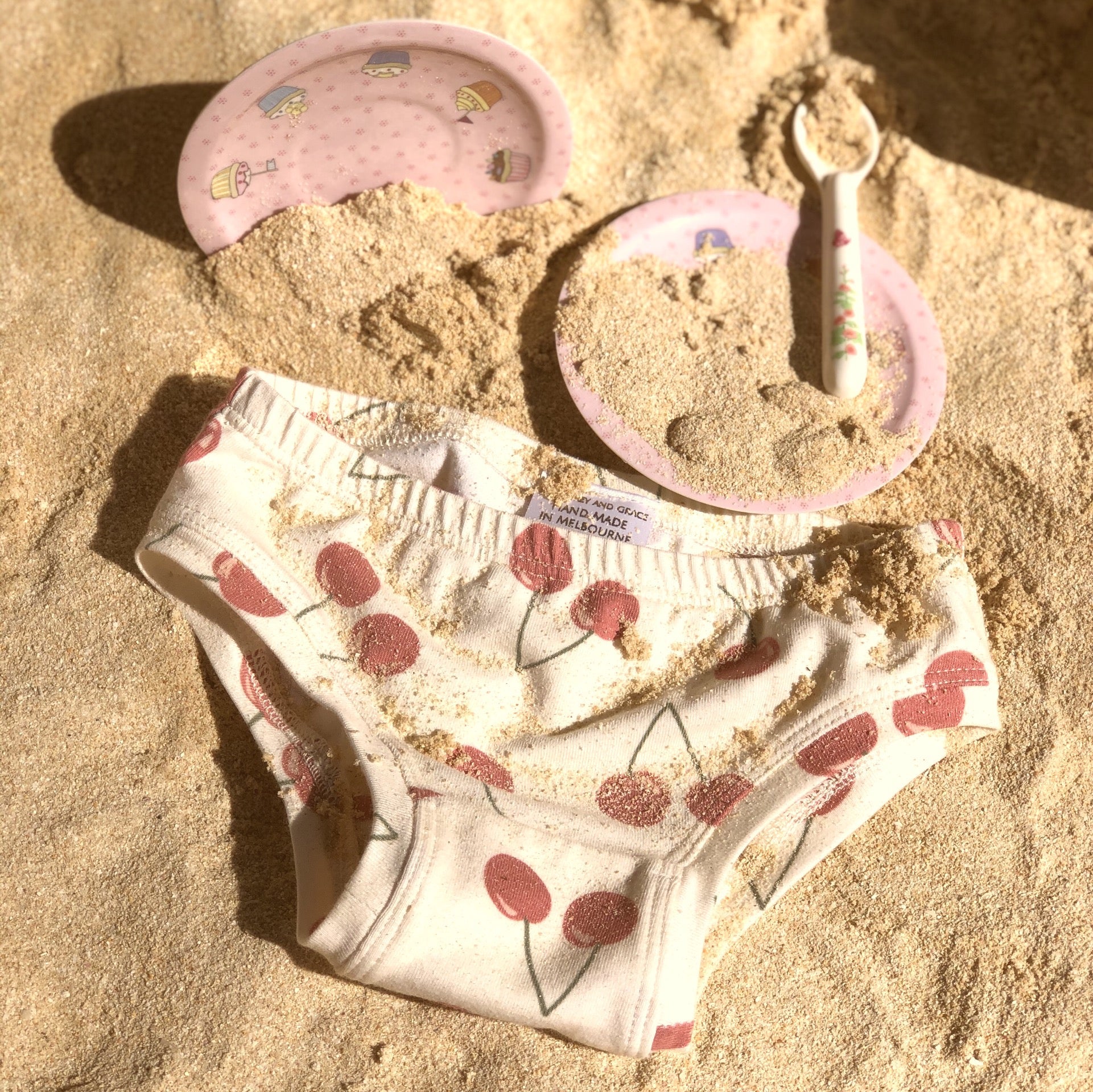 Australian-made children's underwear by Audrey & Grace - printed briefs styled on sand - ethical kids underwear