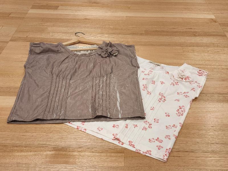 We can see the by Audrey and Grace Zero waste tops in Antique and Hydrangea lying flat on a wooden table.  The Antique coloured top is slightly covering the floral zero waste top