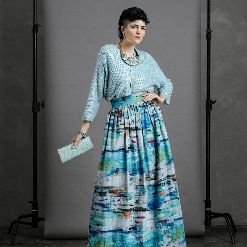 Model in full-length Ocean Skirt with winter boots and knit jumper