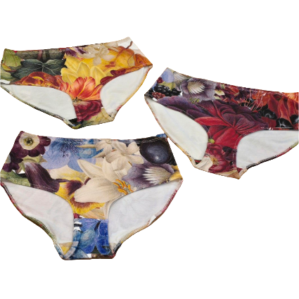 Flat lay of three versions of different print placements of the Big Girls briefs in Big Bloom print on white background.