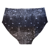 A flat lay of the back of the by Audrey and Grace Night Snow Big Girls briefs on a white background, showing a transitioning black grey mottled print with white dots that look like large snow flakes, covering the print