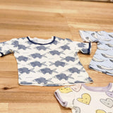 Kids raw edge tee in Fish print, organic cotton — front flat lay with Smiley Hearts and Blue Whales tees