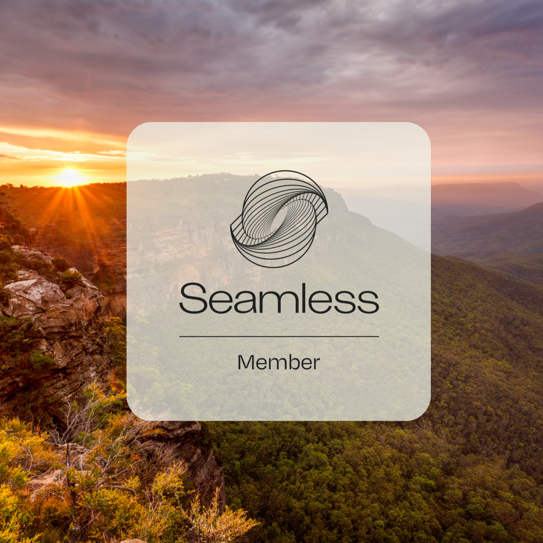 Image of a beautiful sunset beyond the mountains with the Seamless Australia Logo over the top