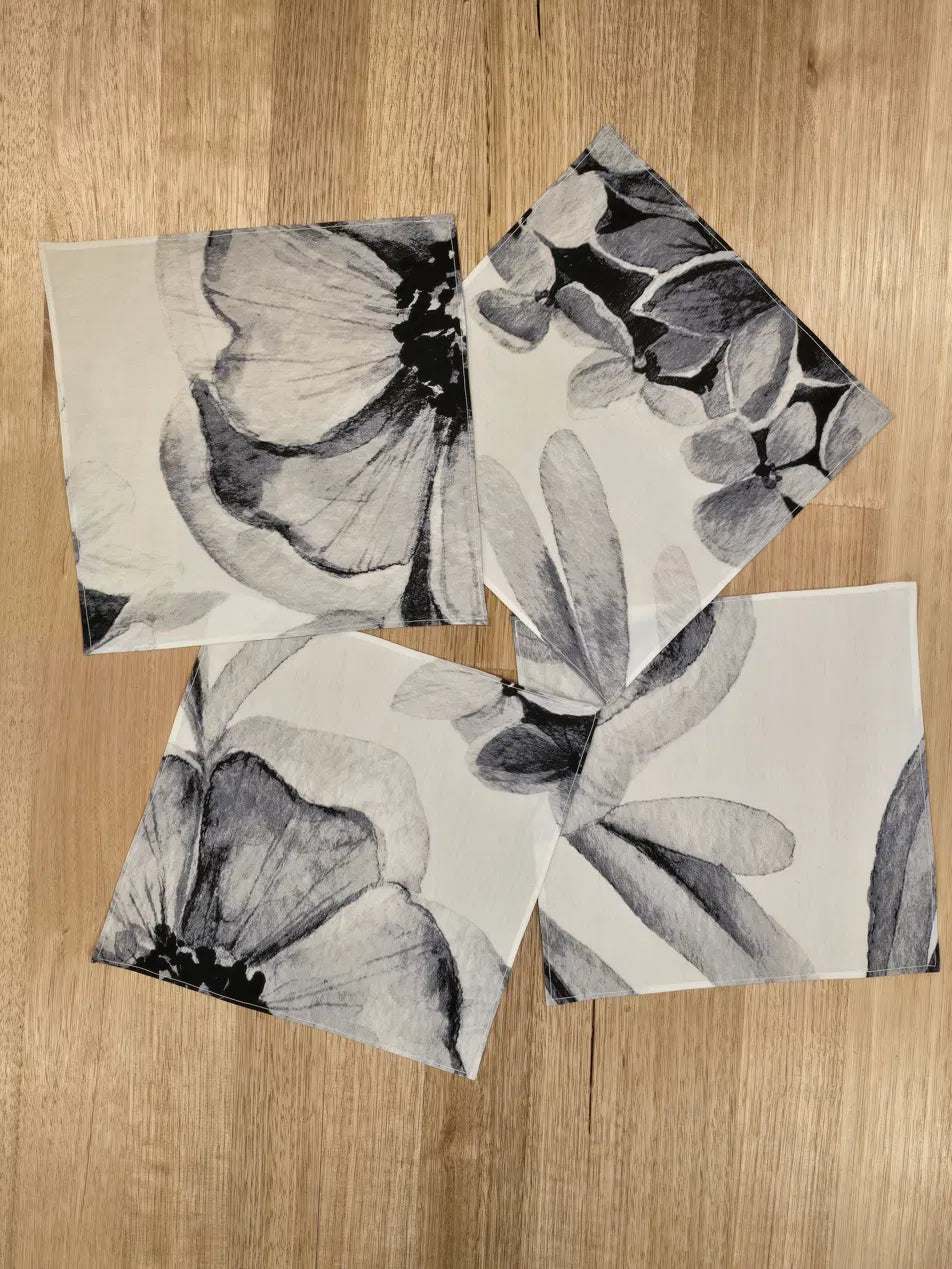 The Floriferous Hankies in 4 of the 5 print options scattered on a wooden table top