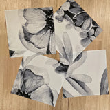 The Floriferous Hankies in 4 of the 5 print options scattered on a wooden table top