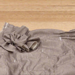 A close up image of the zero waste flower on the by Audrey and Grace Antique coloured Zero Waste top 