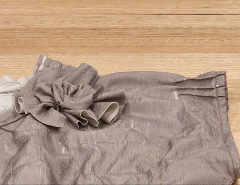 A close up image of the zero waste flower on the by Audrey and Grace Antique coloured Zero Waste top 