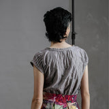 Model wearing the by Audrey and Grace Antique Zero Waste top. She has her back to us, with arms dropped to side and top tucked into the Big Bloom Zero Waste Skirt