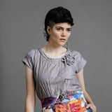 Model wearing the by Audrey and Grace Antique Zero Waste top. We can see the flower detail and the pin tucks and it is worn with the Big Bloom Zero Waste skirt. with models hand in skirt pocket