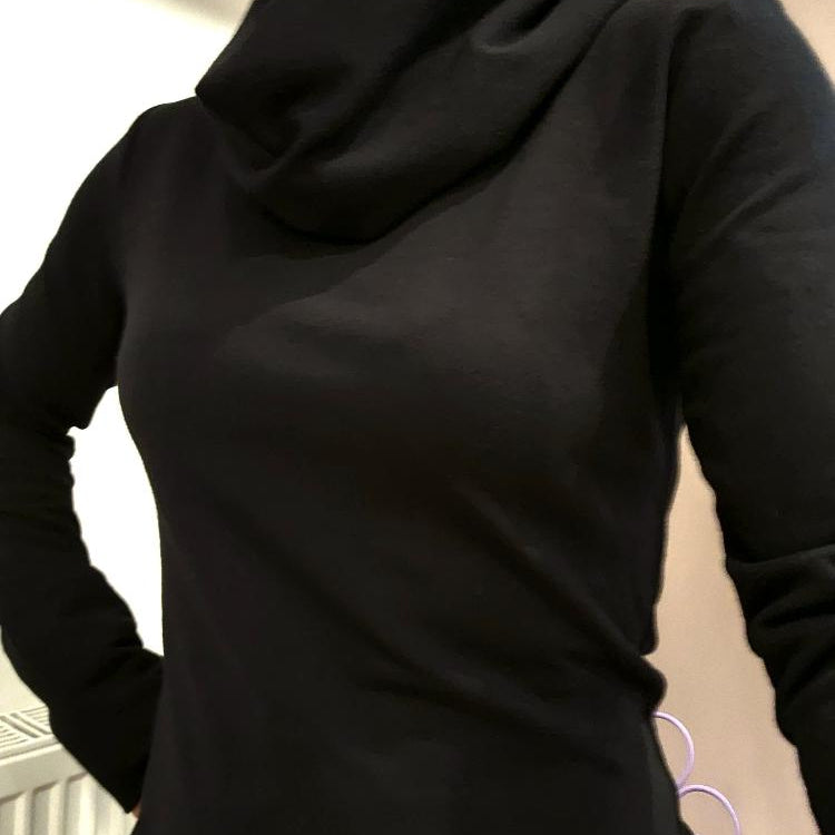 The Black Ruby Jumper with cowl turtleneck, worn by model . Showing a close fitting piece of Australian made womens clothing, accredited by Ethical Clothing Australia.