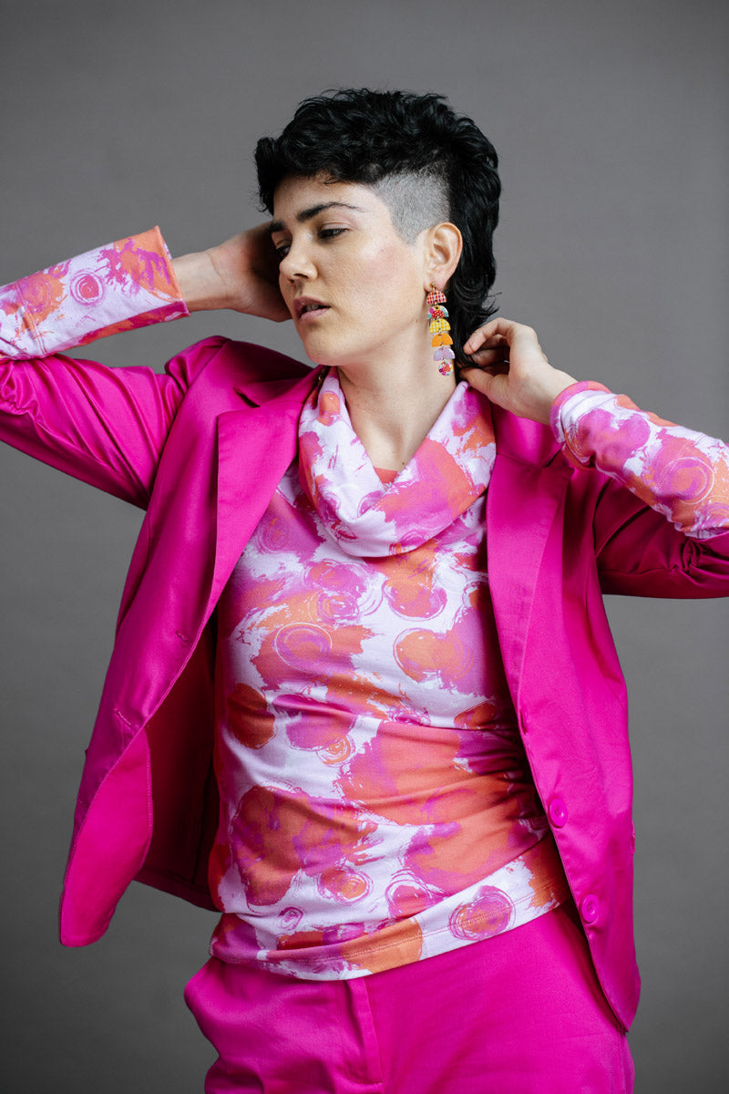 Model wearing a by Audrey and Grace Pink Fairy Floss print Ruby Jumper with a bright mgenta suit and bright coloured earings showing Australian Made womens clothing