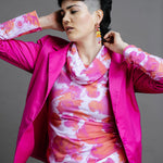 Model wearing a by Audrey and Grace Pink Fairy Floss print Ruby Jumper with a bright mgenta suit and bright coloured earings showing Australian Made womens clothing