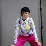 Person wearing the Ruby Jumper Bubbles with pink pants posing against a gray background