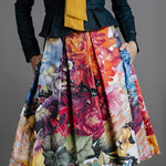 Zero Waste Box Pleat Skirt in Big Bloom, organic cotton — front view on model, styled with fitted denim jacket and mustard blouse, cropped