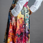 Zero Waste Box Pleat Skirt in Big Bloom, organic cotton — side back view, model has hands in big side pockets and is wearing a white shirt