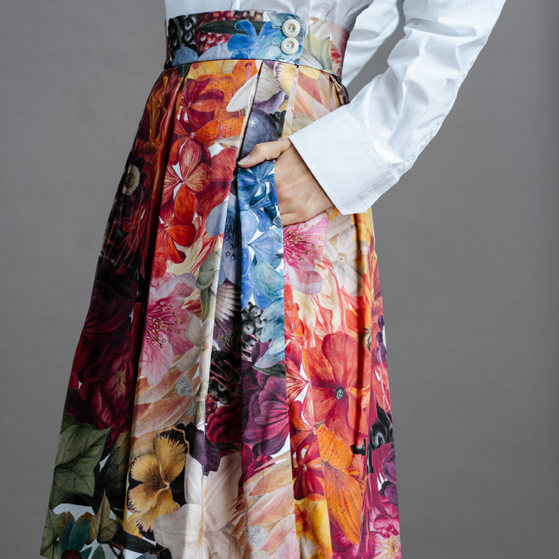 Zero Waste Box Pleat Skirt in Big Bloom, organic cotton — side view, model has hands in big side pockets and is wearing a white shirt