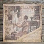 A ladies handkerchief with a special print, depicting a 1920s mother checking the hem length of her littles girls dress as she stands on a stool, with her sewing machine in the background. The imae shows a torn edge with a page of text visible eneath, with an aged feel to the image.