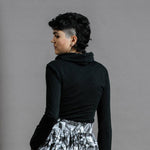 The Ruby Jumper in Black, Australian Women's Jumpers made from Australian cotton — Back facing with left hand in hidden large pocket