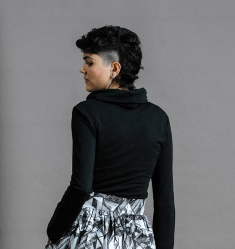 The Ruby Jumper in Black, Australian Women's Jumpers made from Australian cotton — Back facing with left hand in hidden large pocket