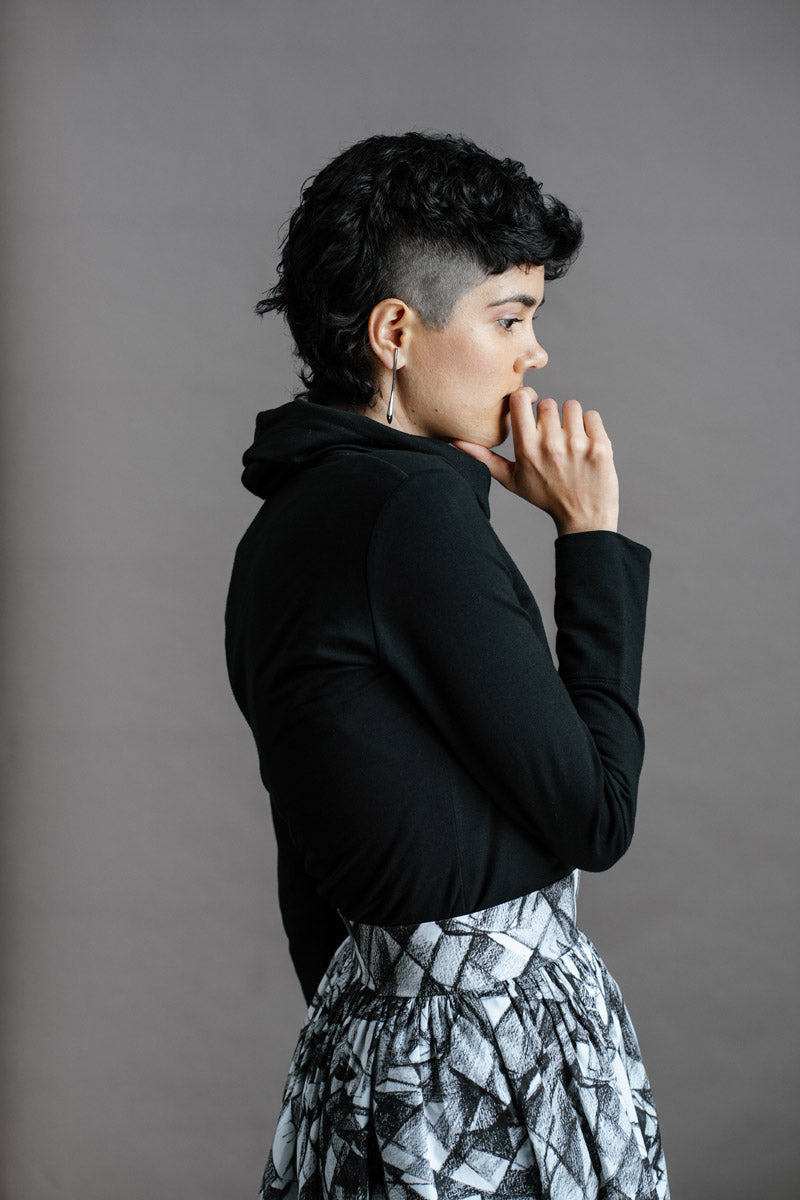 The Ruby Jumper in Black, Australian Women's Jumpers made from Australian cotton — Side on with hand to mouth