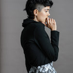 The Ruby Jumper in Black, Australian Women's Jumpers made from Australian cotton — Side on with hand to mouth