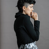 The Ruby Jumper in Black, Australian Women's Jumpers made from Australian cotton — Side on with hand to mouth