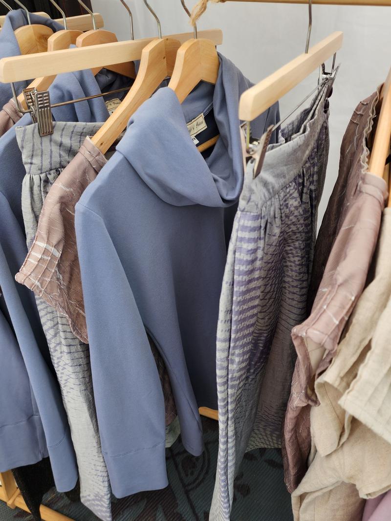 by Audrey and Grace garments hanging on a rack next to the Storm Ruby Jumper
