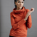 The Ruby Jumper in Terracotta, sustainable and ethical women's jumpers made from Australian cotton — front view with model's hands together and to the side, cropped