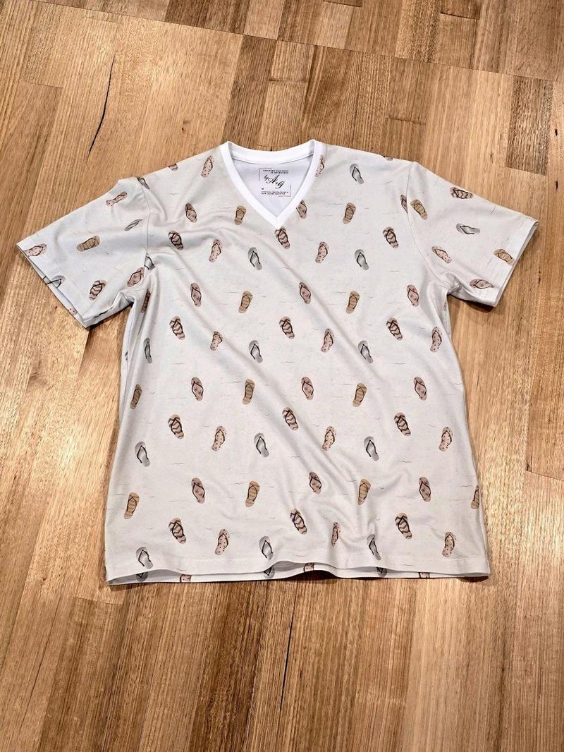 Unisex tee in Thongs print, Australian cotton t-shirt — flat lay front view