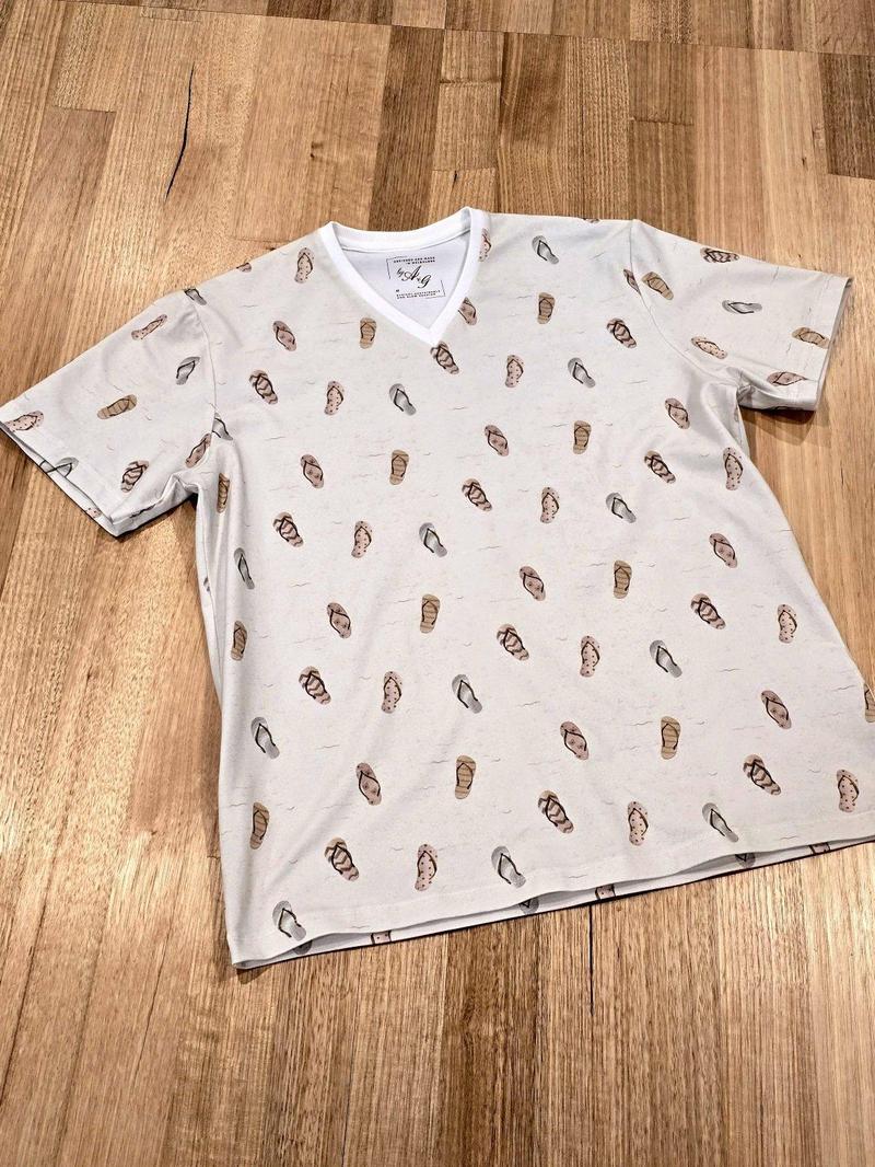 Unisex tee in Thongs print, Australian cotton t-shirt — flat lay front view angled